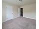 Bright bedroom with neutral walls, plush carpet, and natural light streaming in through the window at 1474 Union Station, Lawrenceville, GA 30045