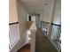 Hallway with iron railing and carpeted floors, leading to bedrooms at 1474 Union Station, Lawrenceville, GA 30045