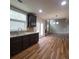Modern kitchen with hardwood floors, stainless steel sink, backsplash, and open to the living area at 1474 Union Station, Lawrenceville, GA 30045