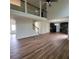 Spacious living area with hardwood floors, high ceilings, an open staircase, and an adjacent kitchen at 1474 Union Station, Lawrenceville, GA 30045
