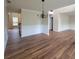 Inviting open-concept living area with hardwood floors, a chandelier, and a view of the staircase to the second floor at 1474 Union Station, Lawrenceville, GA 30045