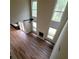 Overhead view of the open-concept living space with hardwood floors, fireplace, large windows, and access to the kitchen at 1474 Union Station, Lawrenceville, GA 30045