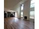 Spacious open-concept living area with hardwood floors, a fireplace, tall ceilings, and abundant natural light at 1474 Union Station, Lawrenceville, GA 30045