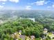 Aerial view of neighborhood showing large lots, mature trees, and a lake at 1620 Bluewater Ct, Cumming, GA 30041