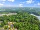 Aerial view of neighborhood showing large lots, mature trees, and a lake at 1620 Bluewater Ct, Cumming, GA 30041