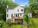 Back exterior of home with large deck overlooking a lush and private backyard at 1620 Bluewater Ct, Cumming, GA 30041