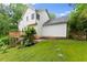 Exterior view of a white home showing the backyard, deck and landscaped yard at 1620 Bluewater Ct, Cumming, GA 30041