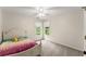 Inviting bedroom with plush carpeting, twin windows, and colorful bedding creating a relaxing retreat at 1620 Bluewater Ct, Cumming, GA 30041