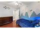 Cozy bedroom featuring playful wall art, hardwood floors, and a bright atmosphere at 1620 Bluewater Ct, Cumming, GA 30041