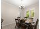 Bright dining room featuring a chandelier and a table set for six, creating an inviting ambiance at 1620 Bluewater Ct, Cumming, GA 30041