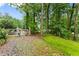 Gravel driveway surrounded by lush trees for privacy at 1620 Bluewater Ct, Cumming, GA 30041
