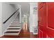 Inviting entryway with hardwood floors, staircase, and convenient coat rack at 1620 Bluewater Ct, Cumming, GA 30041