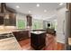 Spacious kitchen with stainless steel appliances, a center island, and a view into the living room at 1620 Bluewater Ct, Cumming, GA 30041