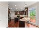 Modern kitchen boasts stainless steel appliances, granite countertops, and access to the deck at 1620 Bluewater Ct, Cumming, GA 30041