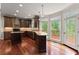 Gourmet kitchen with granite countertops, dark wood cabinetry, and a stainless steel dishwasher at 1620 Bluewater Ct, Cumming, GA 30041