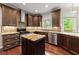Gourmet kitchen with stainless steel appliances, tile backsplash, and a center island at 1620 Bluewater Ct, Cumming, GA 30041