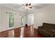 Bright living room with hardwood floors, ceiling fan, and natural light from the windows at 1620 Bluewater Ct, Cumming, GA 30041