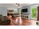 Comfortable living room with hardwood floors, a ceiling fan, and views into the kitchen at 1620 Bluewater Ct, Cumming, GA 30041