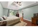 Bright main bedroom featuring vaulted ceiling, hardwood floors, and large windows with views at 1620 Bluewater Ct, Cumming, GA 30041