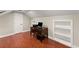 Dedicated home office featuring hardwood floors, built-in bookshelves, and functional workspace at 1620 Bluewater Ct, Cumming, GA 30041