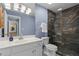 Bathroom featuring dark tiled shower and white sink at 28305 Plantation Ne Dr, Atlanta, GA 30324