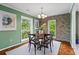 Charming dining room with stone accent wall, hardwood floors, and natural light creates a warm inviting space at 28305 Plantation Ne Dr, Atlanta, GA 30324