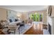 Spacious living room featuring a fireplace, balcony access and stylish furnishings for relaxation and entertainment at 28305 Plantation Ne Dr, Atlanta, GA 30324