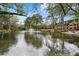 Scenic pond with a fountain surrounded by trees and community buildings at 28305 Plantation Ne Dr, Atlanta, GA 30324