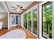 Sunroom with hardwood floors, ceiling fan, and sliding glass doors, with exterior views at 28305 Plantation Ne Dr, Atlanta, GA 30324
