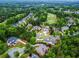 Expansive aerial view of a neighborhood with mature trees, lush lawns, a golf course and luxury homes at 31 Brownson Ct, Acworth, GA 30101