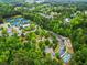 Aerial view highlighting community amenities: tennis courts, playground, and landscaped common areas at 31 Brownson Ct, Acworth, GA 30101