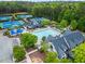Aerial view of the community pool area with a clubhouse, pool, and tennis courts at 31 Brownson Ct, Acworth, GA 30101