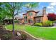 Beautiful back exterior view of the home with its manicured lawn and landscaping, and an outdoor kitchen at 31 Brownson Ct, Acworth, GA 30101
