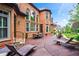Inviting back patio features a table and chairs and plenty of lounge seating, with a beautiful brick home backdrop at 31 Brownson Ct, Acworth, GA 30101