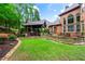 Expansive backyard features a covered patio with stone fireplace and outdoor kitchen, perfect for entertaining at 31 Brownson Ct, Acworth, GA 30101