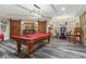 Basement game room featuring a pool table, bar area, and modern lighting fixture at 31 Brownson Ct, Acworth, GA 30101