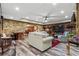 Wide angle view of the basement with stone walls, wood-look floors, and a sectional sofa at 31 Brownson Ct, Acworth, GA 30101