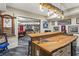 Basement bar with wood countertop, pool table in background, and unique lighting fixture at 31 Brownson Ct, Acworth, GA 30101