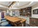 Basement bar with live edge countertop, brick backsplash, and sports decor at 31 Brownson Ct, Acworth, GA 30101