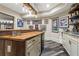 Custom basement bar with a live edge counter top, mini fridge and sports memorabilia at 31 Brownson Ct, Acworth, GA 30101
