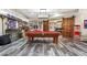 Basement game room with pool table, wood barn doors, and sports memorabilia decor at 31 Brownson Ct, Acworth, GA 30101