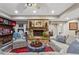 Cozy basement living area with stone fireplace, plush seating, and rustic shelving at 31 Brownson Ct, Acworth, GA 30101