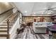 Spacious basement with stone walls, wood-look floors, and a large sectional sofa at 31 Brownson Ct, Acworth, GA 30101