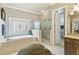 Bright bathroom with a soaking tub, glass enclosed shower, and vanity at 31 Brownson Ct, Acworth, GA 30101