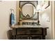 Charming powder room features a granite countertop, decorative mirror, and stylish lighting at 31 Brownson Ct, Acworth, GA 30101