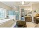 Bright bathroom with a soaking tub, glass enclosed shower, and vanity at 31 Brownson Ct, Acworth, GA 30101