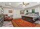 Spacious bedroom with tray ceiling, leather chair, and ensuite bathroom at 31 Brownson Ct, Acworth, GA 30101