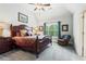 Bedroom with a queen bed, ceiling fan, and a large window bringing in natural light at 31 Brownson Ct, Acworth, GA 30101