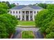Elegant clubhouse with grand columns, lush landscaping, and circular driveway creates a stately presence at 31 Brownson Ct, Acworth, GA 30101