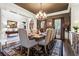 Bright dining room with hardwood floors, wainscoting and modern chandelier with a view to other rooms at 31 Brownson Ct, Acworth, GA 30101